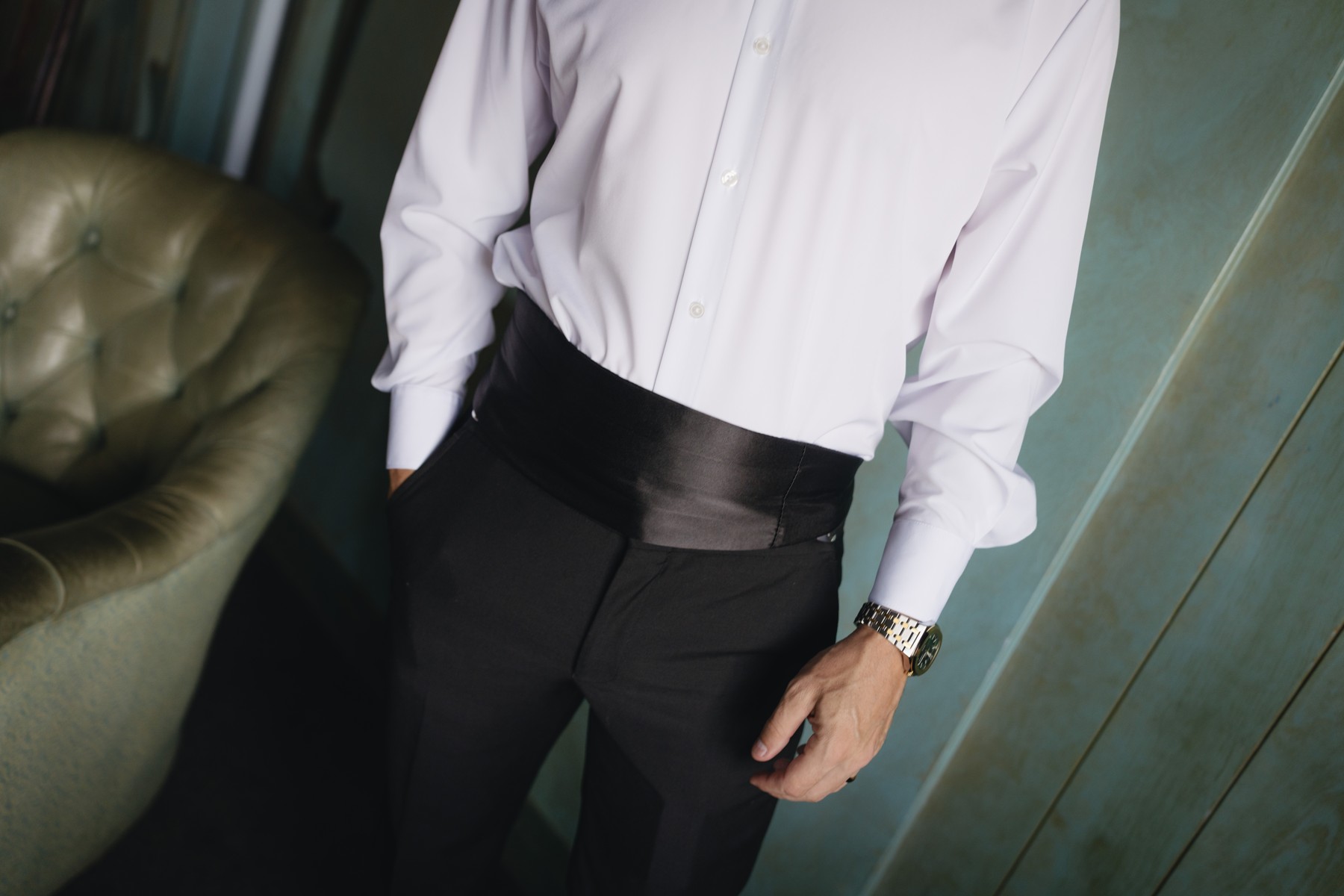 A close-up of the groom’s tuxedo and watch